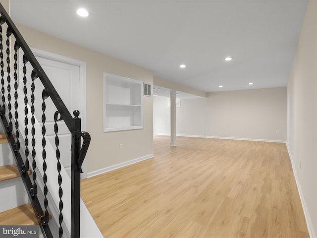 9301 Reef Ct, Alexandria, VA 22309 - finished below grade area with light wood-style floors, stairway, baseboards, and recessed lighting