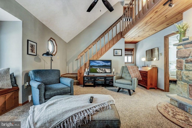 carpeted living room featuring vaulted ceiling and ceiling fan