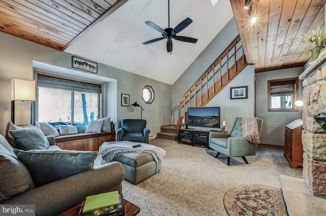 carpeted living room with ceiling fan, vaulted ceiling, a wealth of natural light, and wood ceiling