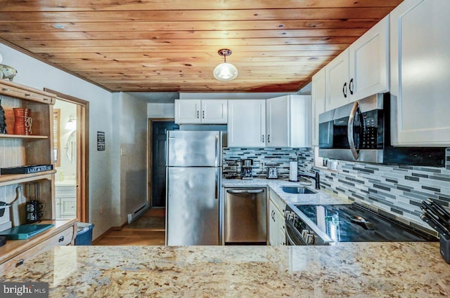 kitchen featuring light stone counters, white cabinets, and appliances with stainless steel finishes