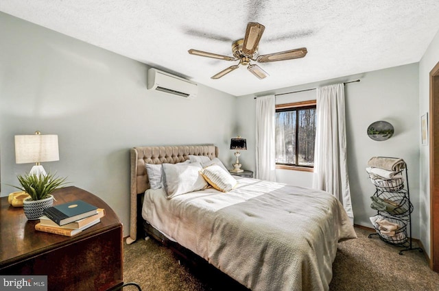 carpeted bedroom featuring ceiling fan, a wall mounted AC, and a textured ceiling