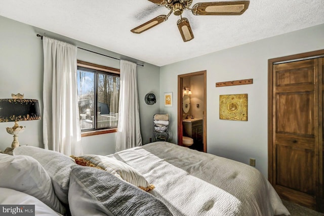 bedroom featuring ceiling fan, a textured ceiling, and ensuite bath