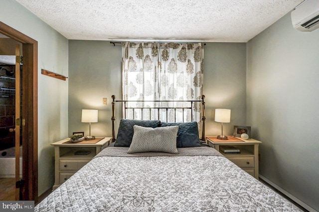 bedroom featuring a wall mounted air conditioner and a textured ceiling