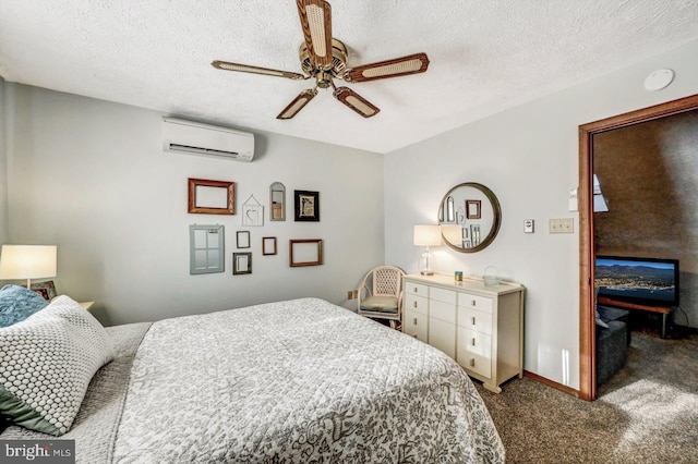 bedroom with ceiling fan, carpet floors, a wall mounted air conditioner, and a textured ceiling