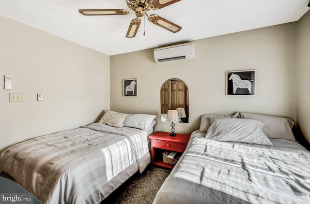 bedroom with ceiling fan, an AC wall unit, and dark carpet