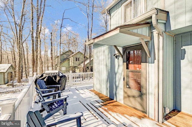 snow covered deck with grilling area