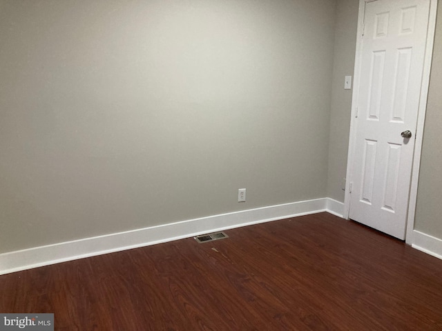 spare room featuring dark hardwood / wood-style floors