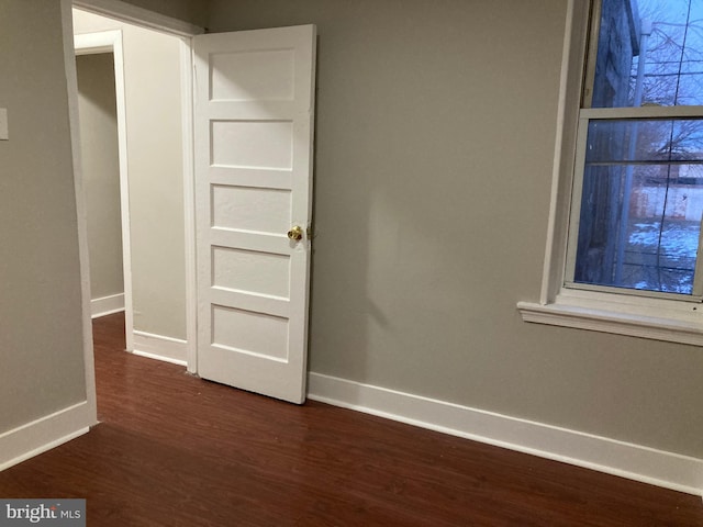 spare room featuring dark hardwood / wood-style flooring