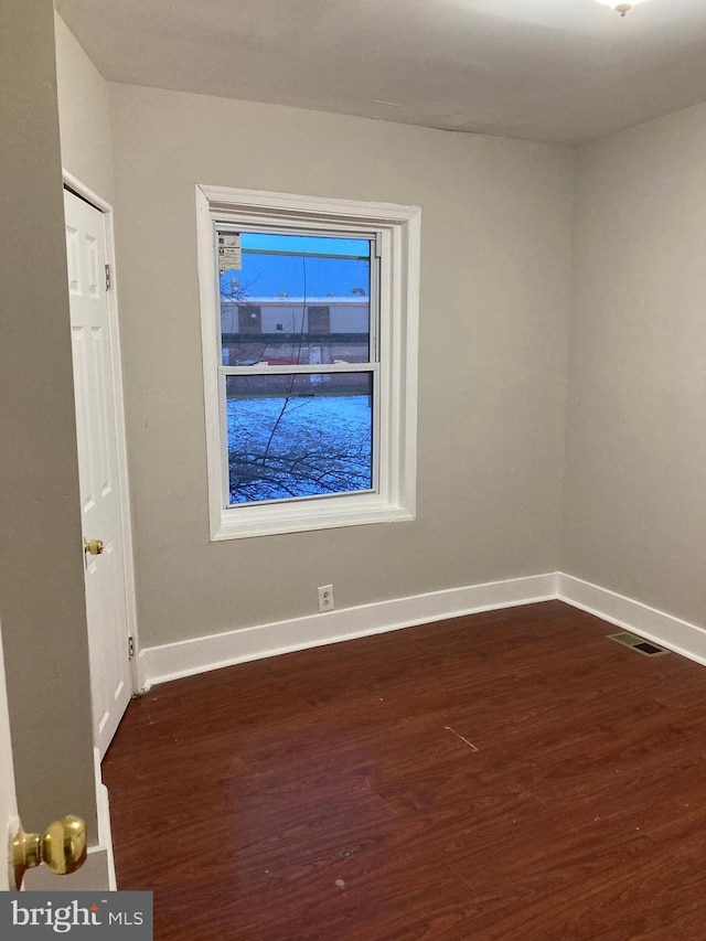 spare room featuring dark hardwood / wood-style flooring