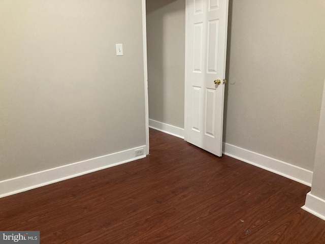 spare room with dark hardwood / wood-style flooring