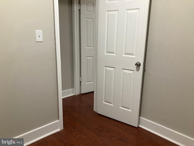 corridor featuring dark wood-type flooring