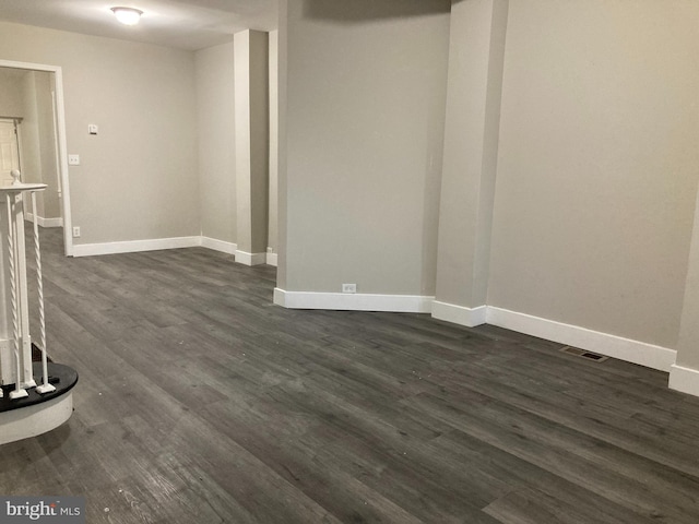 empty room with dark hardwood / wood-style flooring