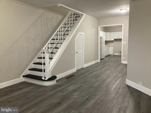 stairs featuring hardwood / wood-style floors