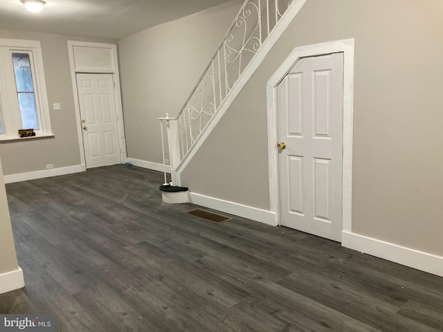 foyer entrance with dark wood-type flooring