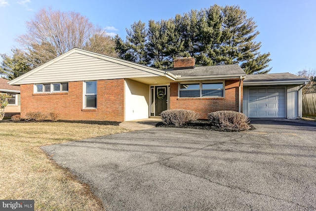 view of front of property with a garage and a front lawn