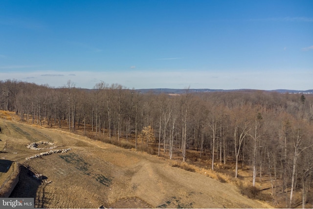 exterior space with a rural view and a view of trees