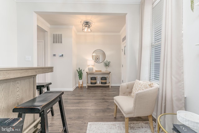 living area with dark wood-style floors, baseboards, visible vents, and ornamental molding