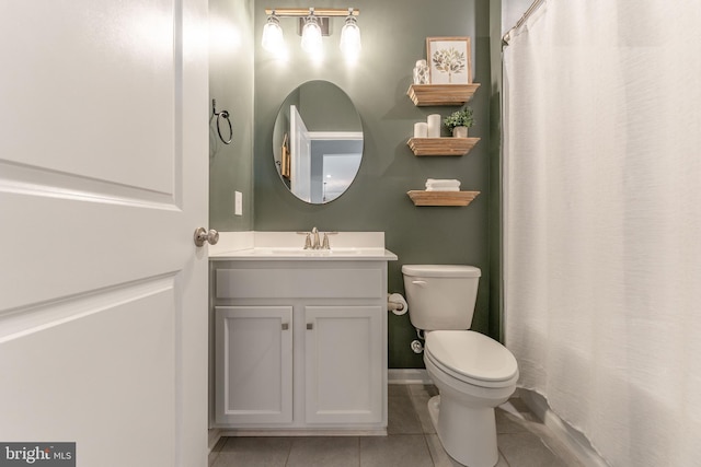 full bath with toilet, baseboards, vanity, and tile patterned floors