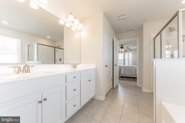 full bathroom featuring visible vents, connected bathroom, tile patterned flooring, a shower stall, and a sink