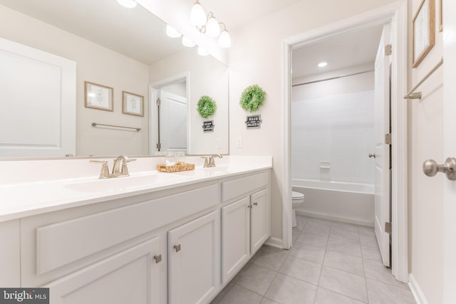 full bathroom featuring double vanity, toilet,  shower combination, tile patterned flooring, and a sink