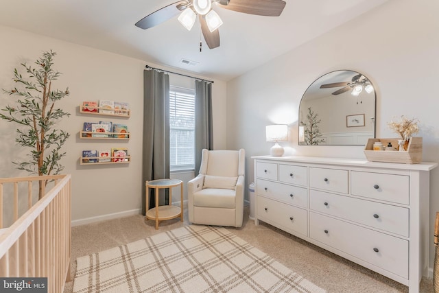 sitting room with baseboards, a ceiling fan, visible vents, and light colored carpet