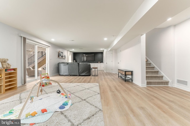 recreation room with baseboards, visible vents, wood finished floors, and recessed lighting