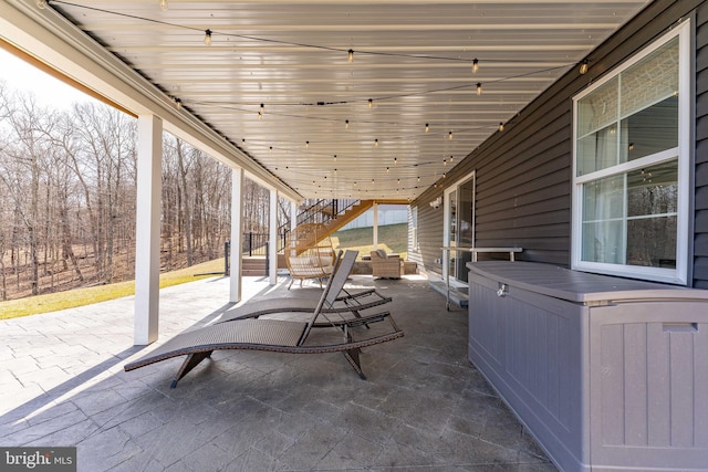 view of patio / terrace featuring stairs and outdoor lounge area