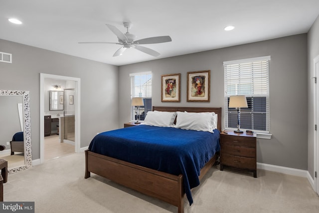 bedroom featuring ensuite bath, recessed lighting, baseboards, and light colored carpet