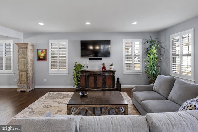 living area with recessed lighting, dark wood finished floors, and baseboards