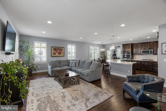 living room with baseboards, recessed lighting, dark wood finished floors, and a healthy amount of sunlight