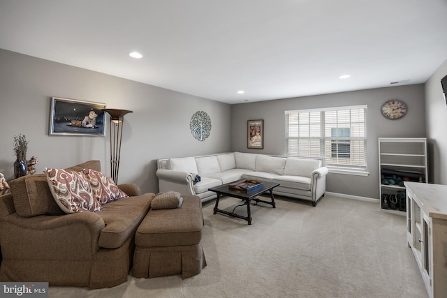 living room featuring light carpet, baseboards, and recessed lighting