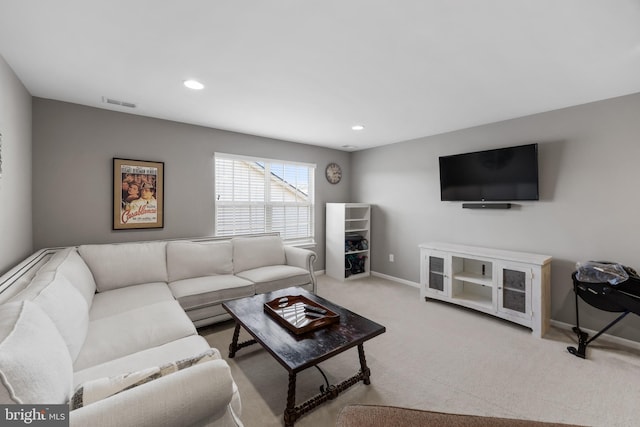 living area with carpet floors, recessed lighting, visible vents, and baseboards