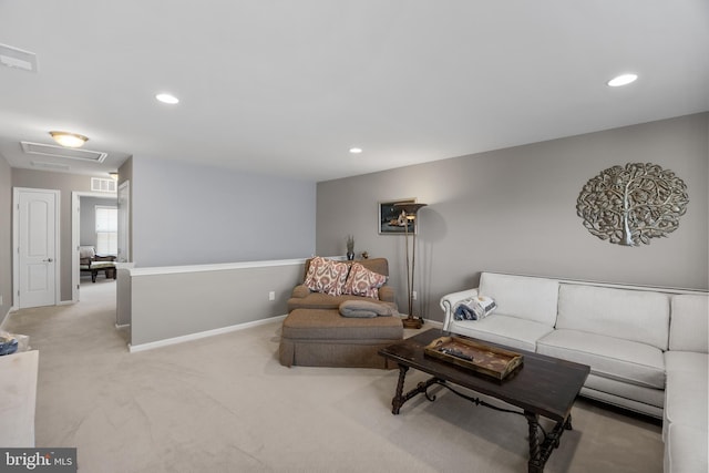 living room with light carpet, attic access, visible vents, baseboards, and recessed lighting