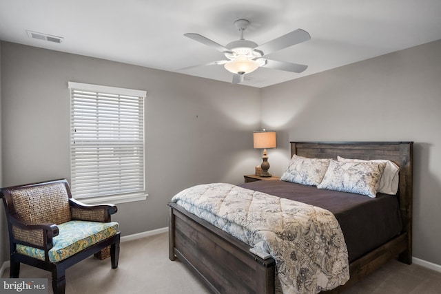 carpeted bedroom with baseboards, visible vents, and ceiling fan