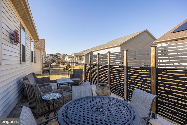 view of patio featuring outdoor dining space, outdoor lounge area, and fence