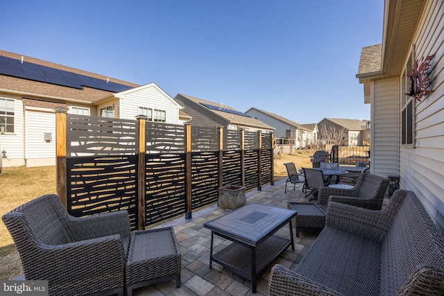 view of patio / terrace with a residential view, fence, and an outdoor living space