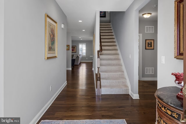 foyer entrance with dark wood-type flooring, visible vents, and recessed lighting