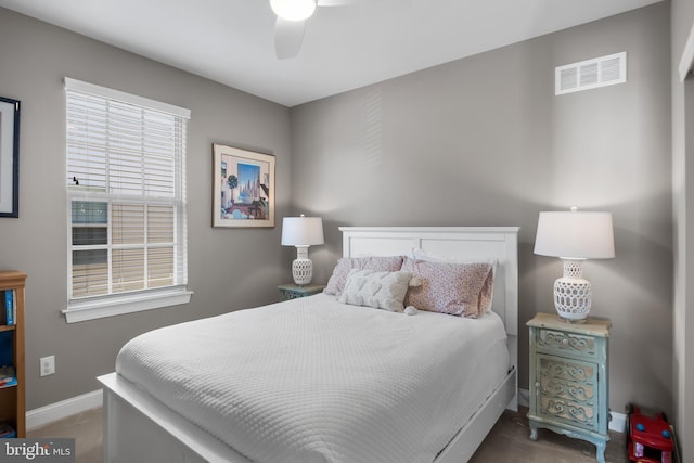 bedroom with ceiling fan, visible vents, and baseboards