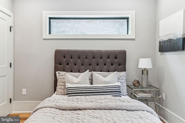 bedroom featuring multiple windows and wood-type flooring