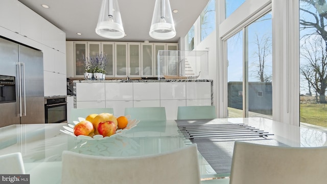 kitchen featuring oven, white cabinets, and high end refrigerator