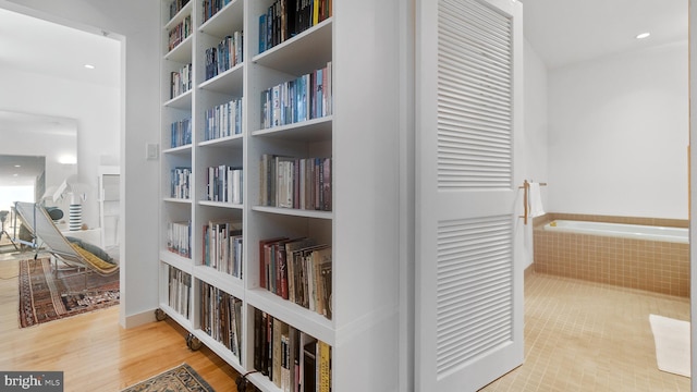 corridor featuring recessed lighting and wood finished floors