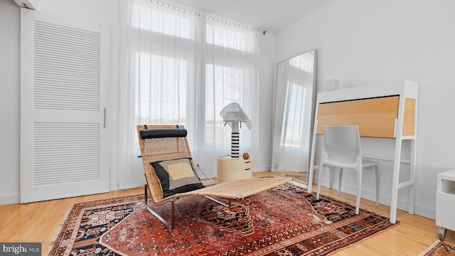 living area featuring baseboards and wood finished floors