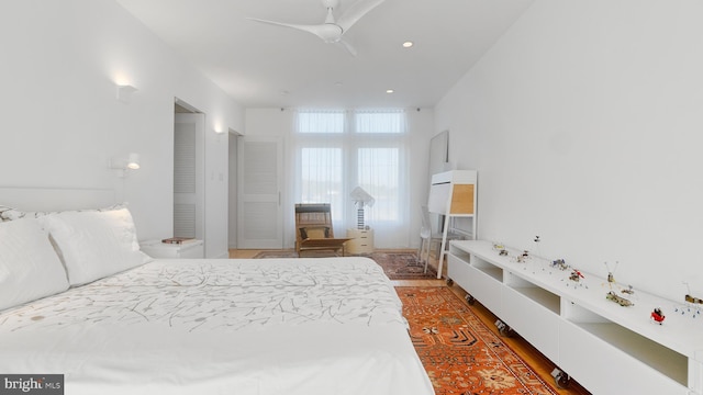 bedroom featuring a ceiling fan, recessed lighting, and wood finished floors