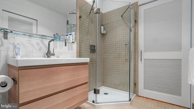 bathroom with vanity and a shower stall