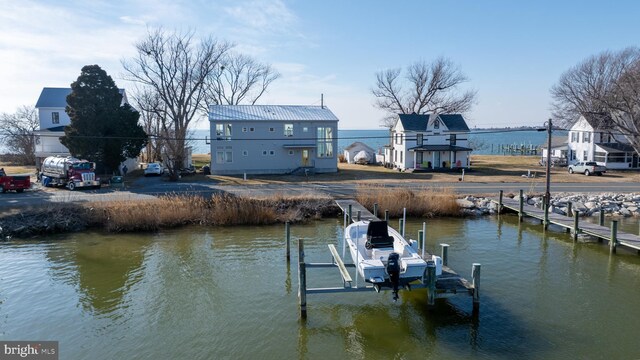 view of dock with boat lift and a water view