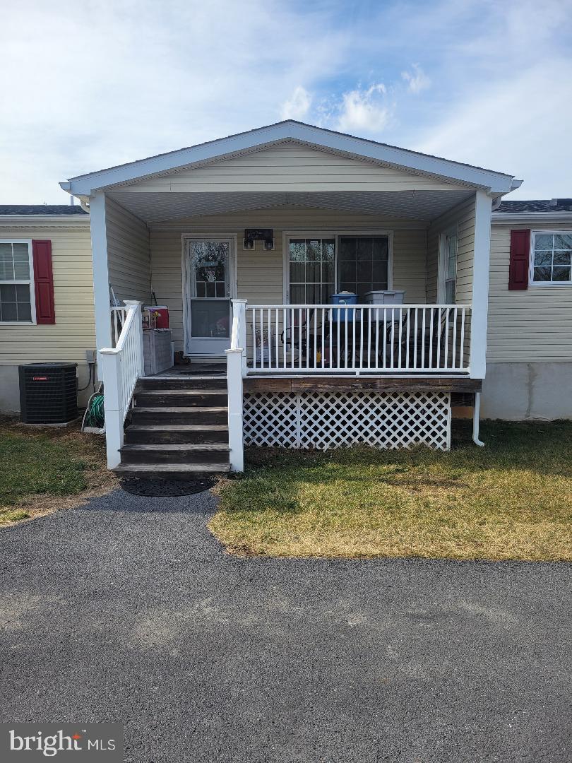 manufactured / mobile home featuring central air condition unit and a porch