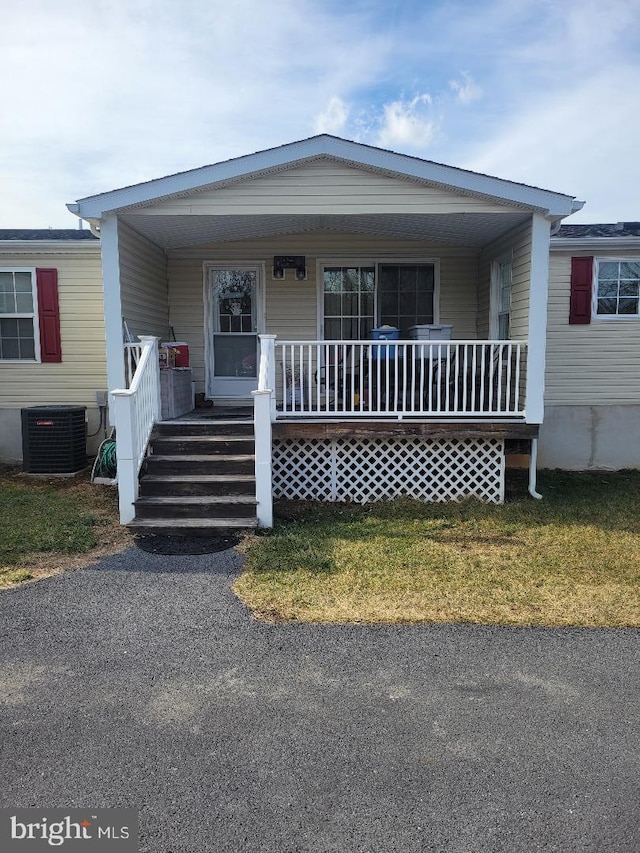 manufactured / mobile home featuring central air condition unit and a porch