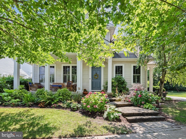 view of property hidden behind natural elements featuring a front lawn