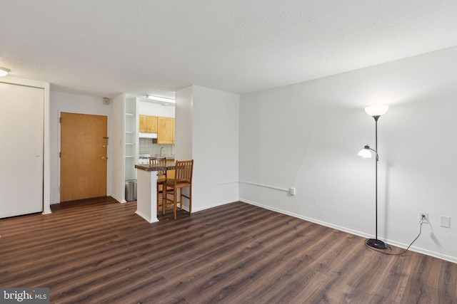 unfurnished living room featuring dark hardwood / wood-style floors