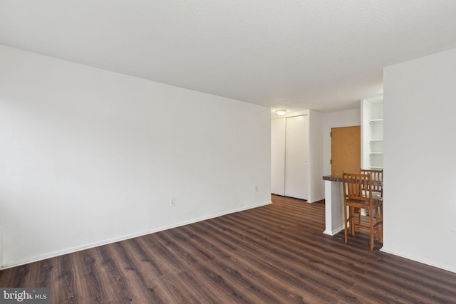 empty room featuring dark hardwood / wood-style floors and a textured ceiling